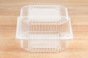 Plastic food package on wooden background