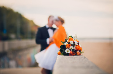 Beautiful wedding flower bouquet with orange roses and  camomile..  decor, idea, background. Bride ...