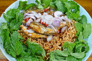 spicy instant noodle with fish canned salad on dish