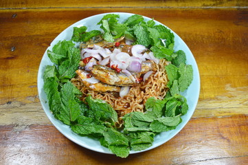 spicy instant noodle with fish canned salad on plate
