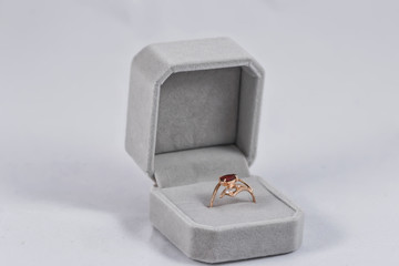 Gold ring with small ruby in gift box