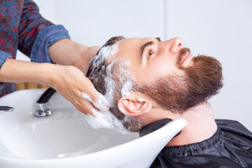 man having his hair washed in a hairdressing salon © khosrork