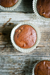 Chocolate muffins on a wooden background