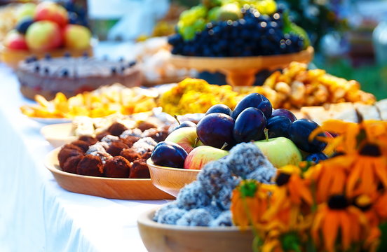 Beautiful wedding feast in nature, abundance of meals on a table.