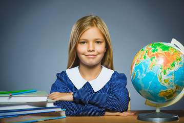 Fototapeta premium school concept. girl sitting at the desk in the classroom Geography