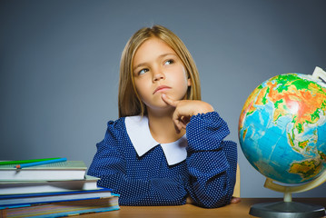 school concept. girl thinking or sitting at the desk in the classroom Geography