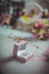 Wedding accessories. Ring box, gold rings and flowers for bridesmaids. Selective focus