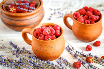 pottery with strawberries and lavender on wooden table