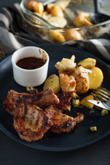 Overhead view of chop with potato and cauliflower. Rustic styled