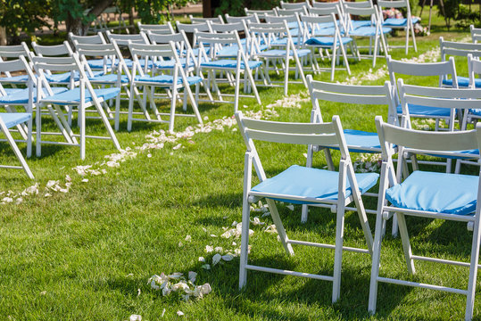 Many white wooden chairs on the wedding ceremony outdoor