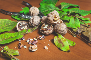 Several walnut kernels and lie on brown background