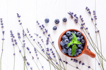 blueberries in a clay bowl with lavender top view