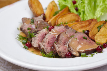 Tasty roasted pork meat with potatoes