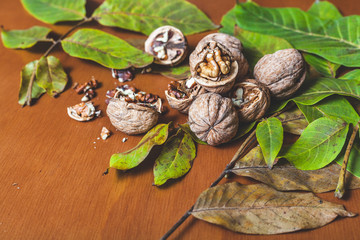Fototapeta na wymiar Several walnuts lie on brown background