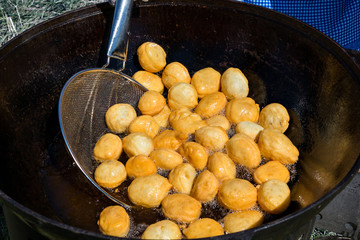Cooking in a cauldron Central Asian national food - baursak