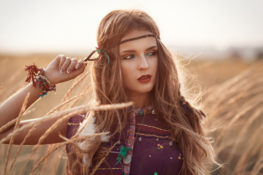 Fashion portrait of beautiful hippie woman at the sunset summer