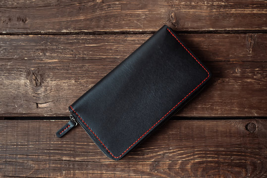 leather wallet on a wooden board
