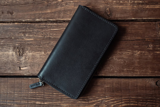 leather wallet on a wooden board