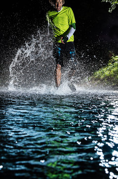 Single Runner Running, Making Splash In A Stream.