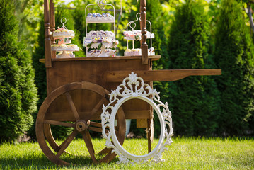 Decorative wooden cart in the garden and candy bar
