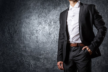 Man in suit against concrete wall