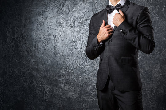 Stylish man in suit with bow tie