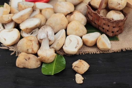 Fresh mushrooms for cooking on wood background.