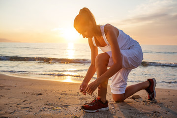 Caucasian woman jogging at seashore