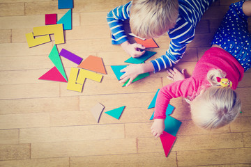 little boy and girl playing with geometric shapes