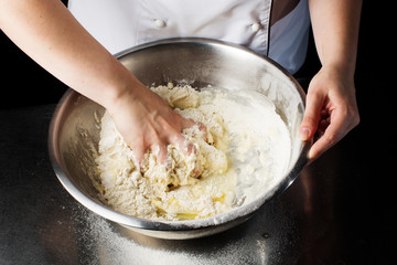 Woman hands kneading dough.