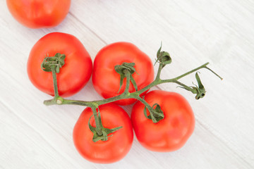 Picture of vine tomatoes on a white wooden background