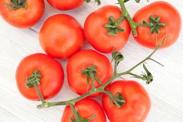 Picture of vine tomatoes on a white wooden background