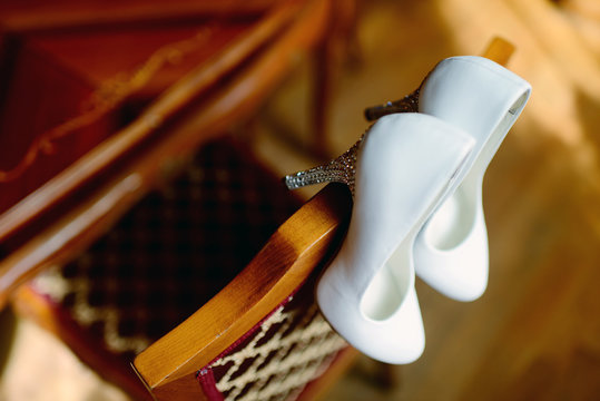 Beautiful colorful wedding shoes for bride indoors. Beauty of bridal heel for marriage. Female couple boots for celebration