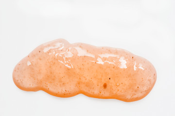 Blob of orange body scrub on white