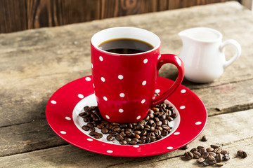 Red mug of coffee  with cream