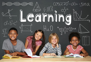 Cute kids reading books on grey background. Back to school concept