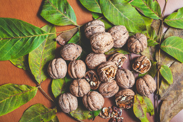 Several walnuts lie on brown background