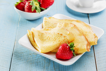 fried pancakes with strawberries breakfast