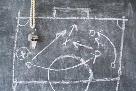 football or tactics blackboard with diagram and whistle 