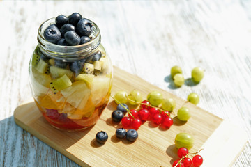 Fruit slices in jar on table