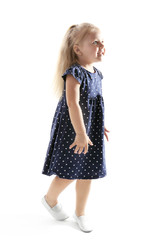 Funny little girl dancing on white background