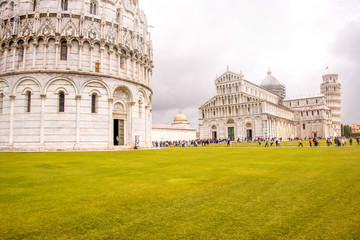 Fototapeta premium Pisa cathedral with baptistery and leaning tower on the field of Miracles in Pisa town in Italy