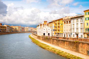 Pisa cityscape view on Arno river with Santa Maria Della Spina church in Italy