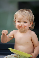 Happy boy eating chocolate cake