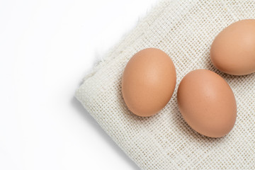 Chicken brown eggs on sackcloth white background
