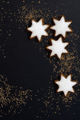 Fototapeta na wymiar black background with a gingerbread in the form of stars, top vi