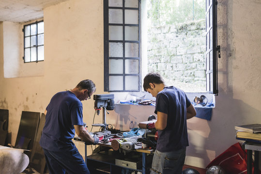 Two forgers working in workshop