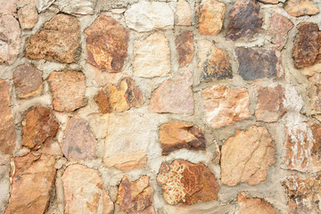 Background wall made of stones held together with cement.