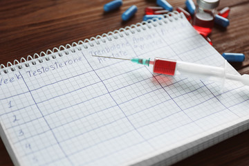 Syringe with pills and notebook. Doping in sport concept