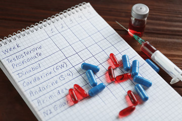 Syringe with pills and notebook. Doping in sport concept